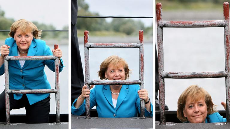 Merkel lächelt in die Kmaera, im Hintergrund ist der Reichstag zu sehen. 
