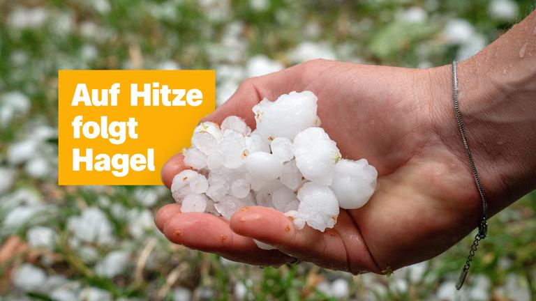 Auf Hitze folgt Hagel; Eine Hand voll mit weißen Hagelkörnern.