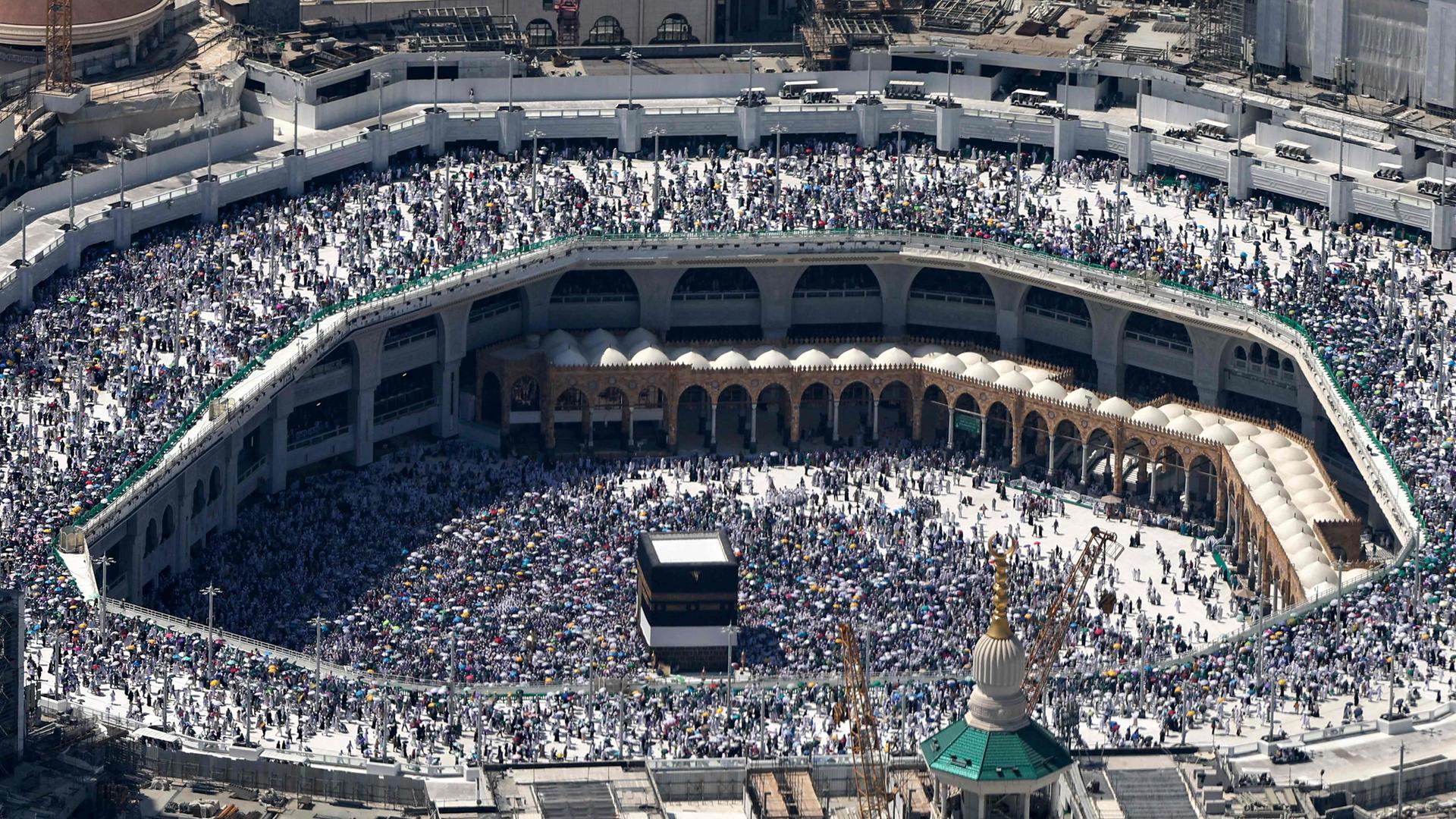 Vogelperspektive der großen Moschee in Mekka in Saudi-Arabien. Zu sehen sind tausende pilgernde Muslime. 