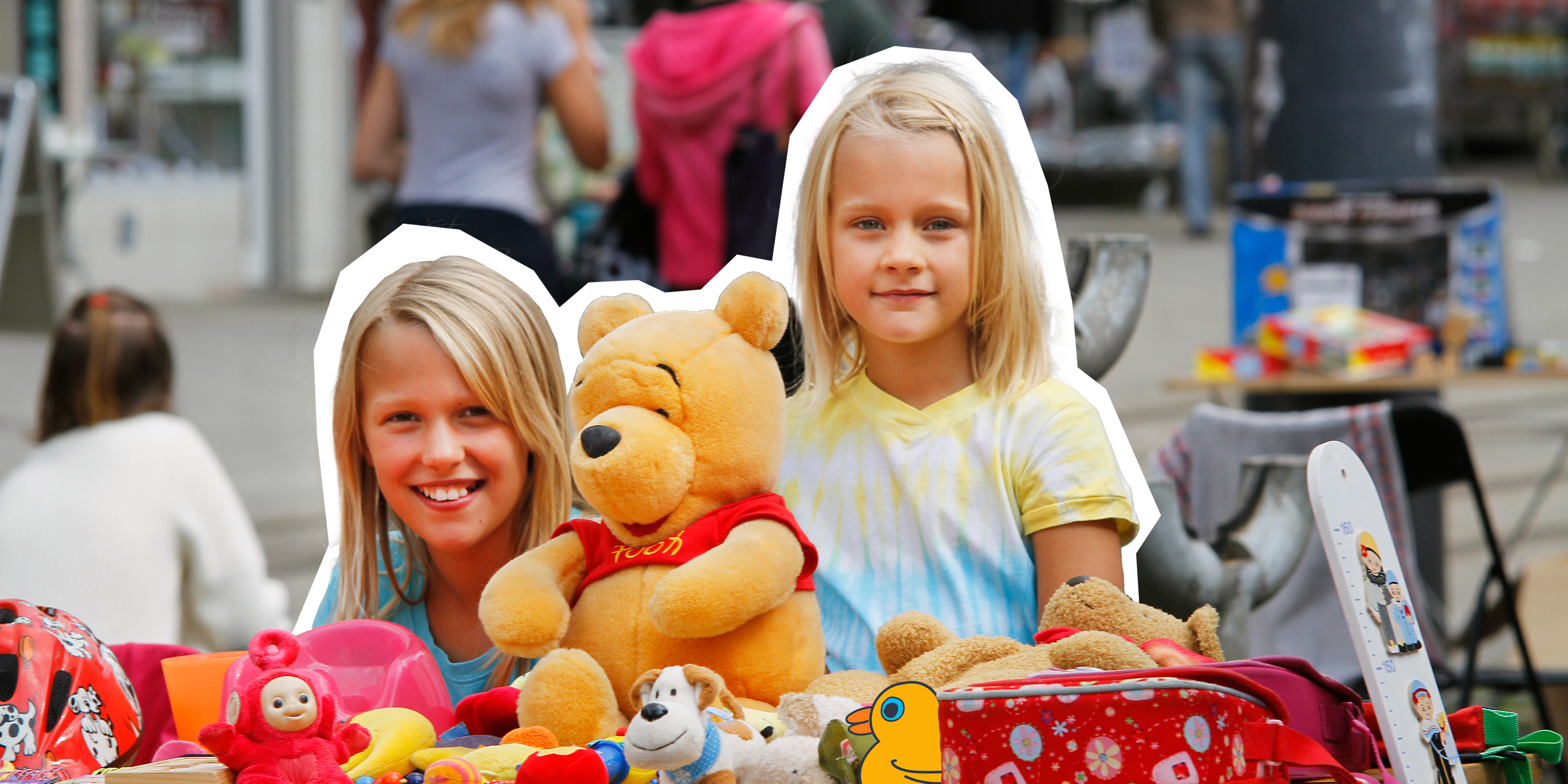 Zwei mädchen, die hinter ihrem verkausstand auf dem Flohmarkt stehen. 