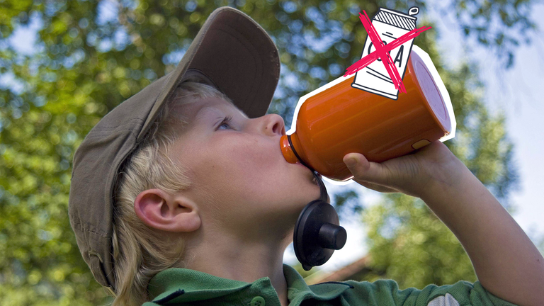Ein Junge trinkt aus einer Trinkflasche.