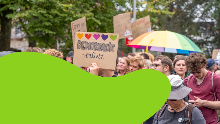 Menschen mit Plakaten auf einer Demo 