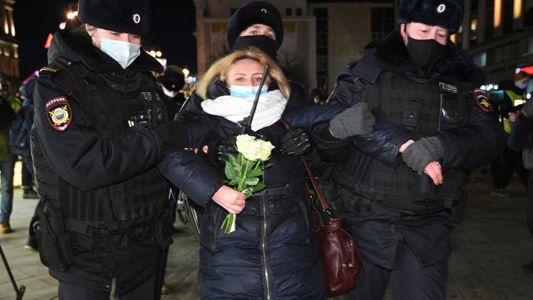 Polizisten führen Demonstrantin in Russland ab