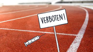 Ein Spritze auf einer Laufbahn. Daneben steht ein Schild auf dem "Verboten" steht.