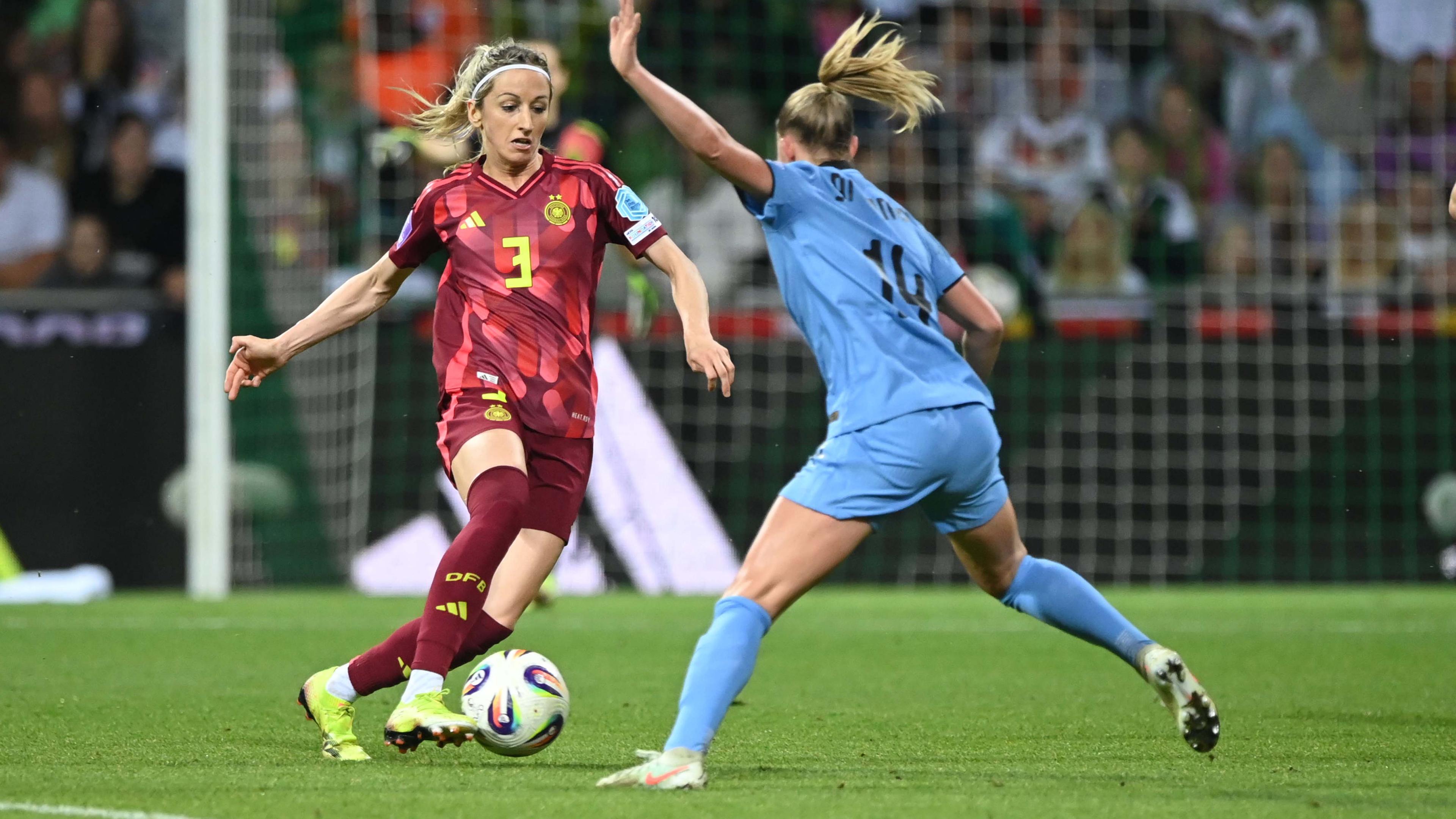 Kathrin Hendrich ist am Ball, vor ihr steht eine Gegnerin auf dem Fußballplatz
