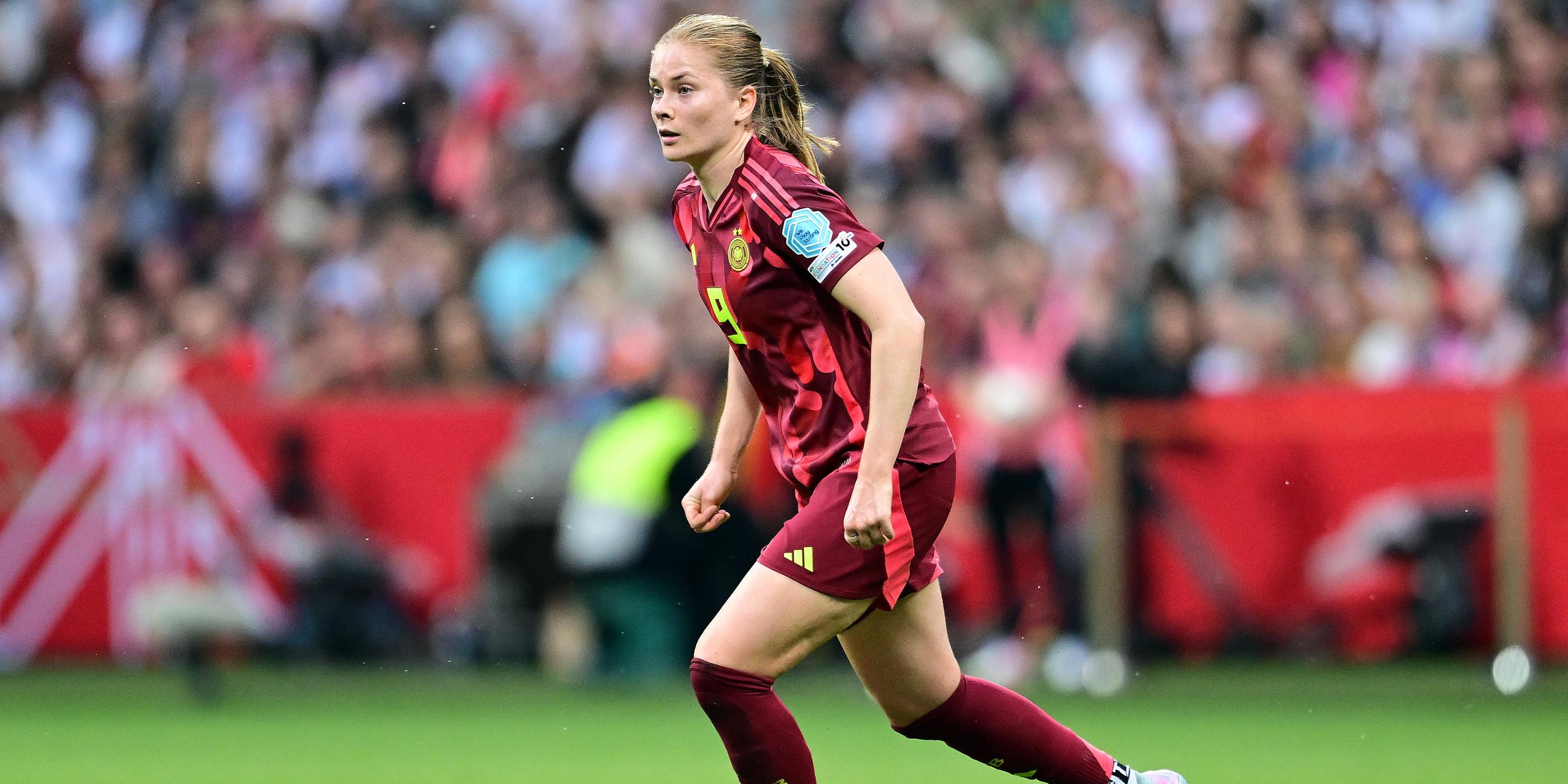 Sjoeke Nuesken ist gerade am Ball und schaut nach vorne, sie ist auf dem Fußballplatz