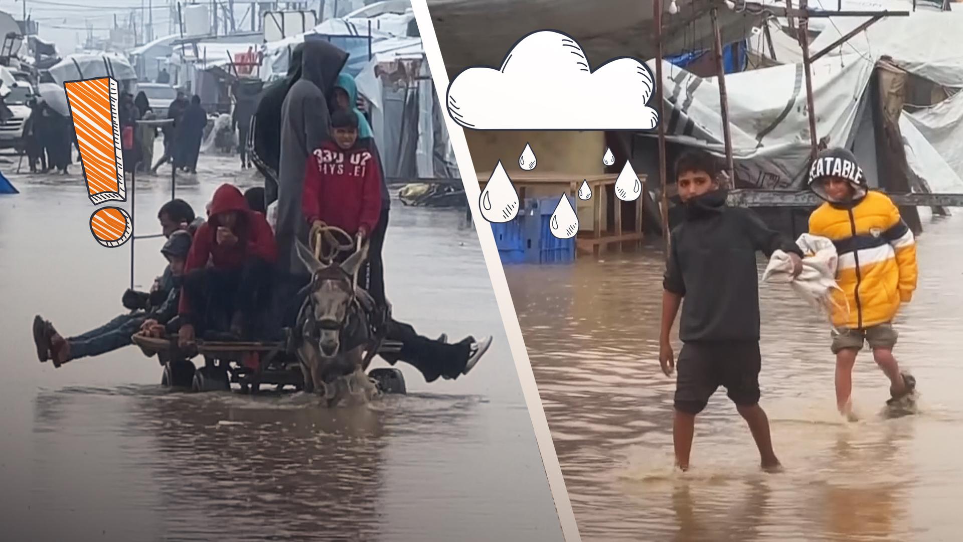 Kinder, die durch kiehohes Wasser laufen im Gazastreifen.