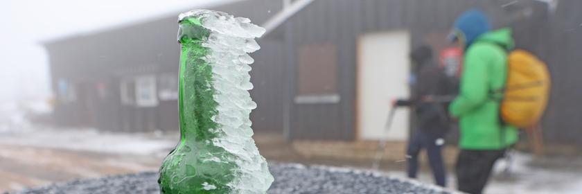 Mit Eis bedeckte Glasflasche im Harz