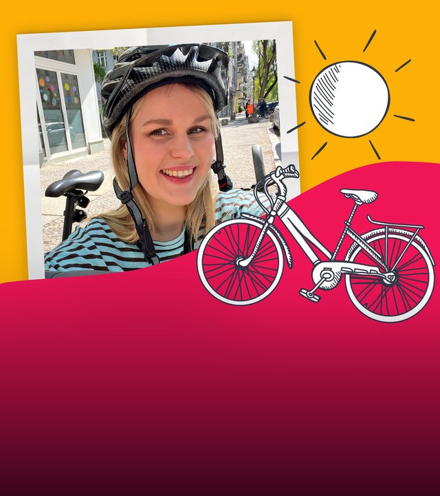 Isabelle mit einem Fahrradhelm und ihrem Farrad auf einer bunten Farbfläche