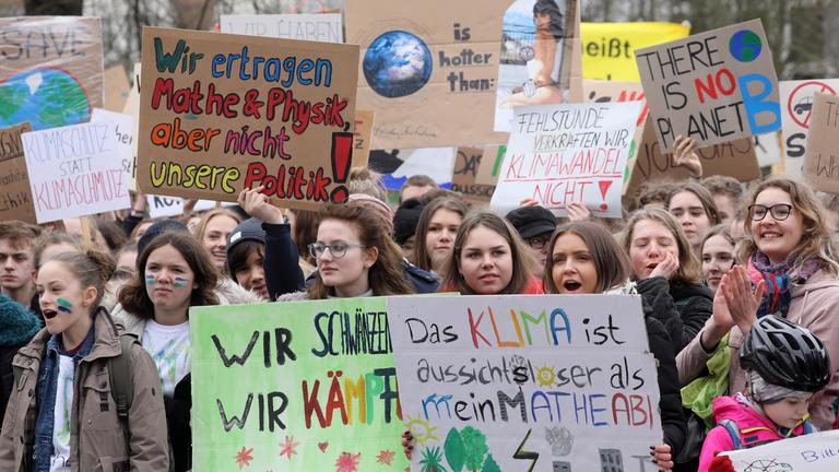 Schüler und Schülerinnen mit Plakaten bei einer Klima-Demonstration. 