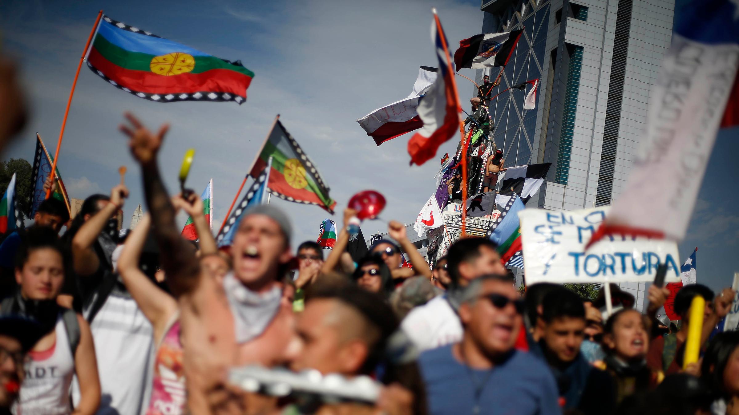 Menschen demonstrieren auf den Straßen in Chile. 