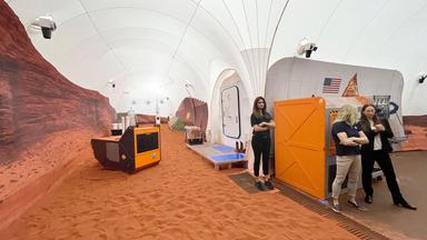 Ein Sandkasten mit rotem Sand, der die Marslandschaft simuliert am 11.04.2023 im Johnson Space Center in Houston, Texas.