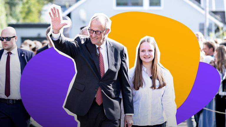 Bundeskanzler Friedrich Merz ist, gekleidet in Anzug und Krawatte links neben einer Jugendlichen in weißer Bluse zu sehen. Sie scheinen durch eine Menschenmenge zu gehen. Merz winkt und lächelt. Schräg hinter ihm geht ein Mann mit Anzug und Sonnenbrille, womöglich ein Bodyguard. 