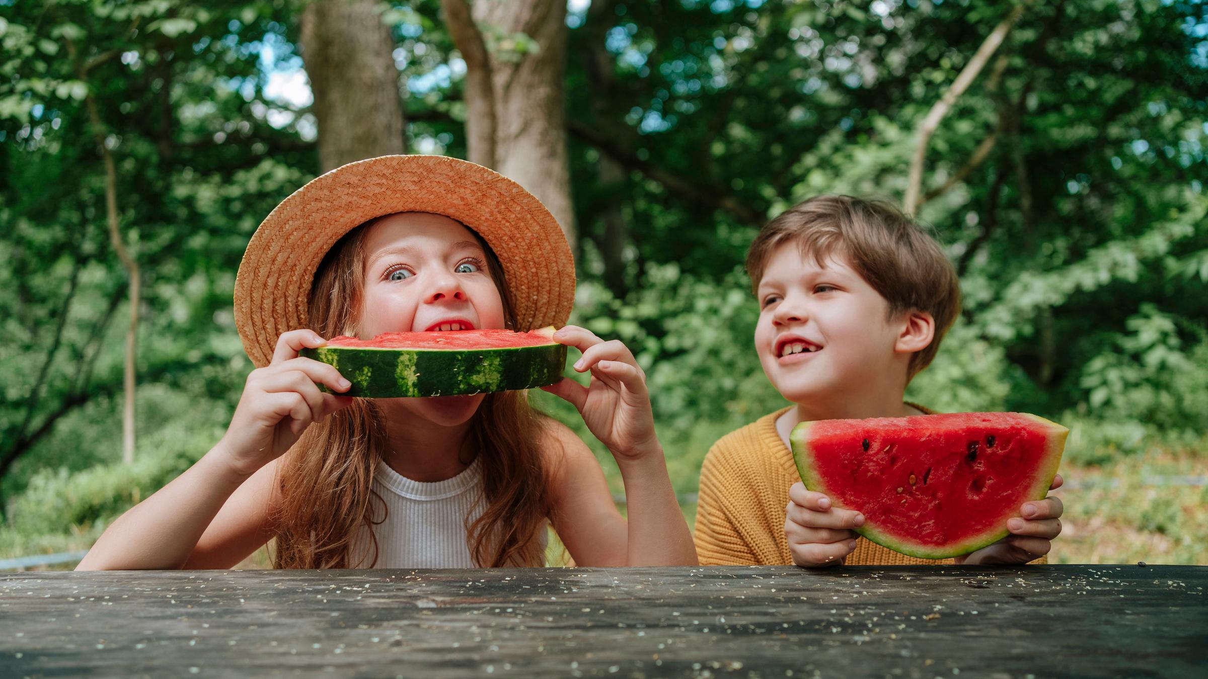 Mädchen beißt in Melone