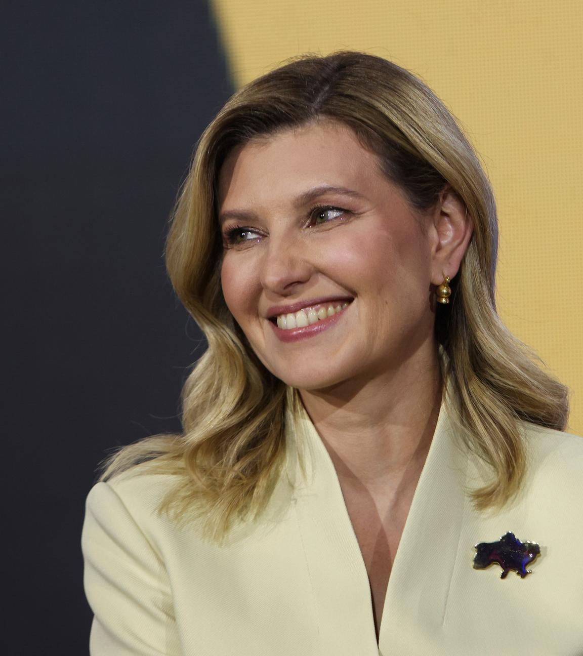 Die First Lady der Ukraine, Olena Selenska, lächelt jemandem in der Ferne zu. 