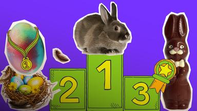 Kaninchen auf Podest, Ei mit Medaille, Osterhase mit Auszeichnung und ein Osternest