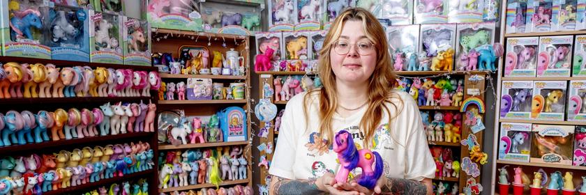 Frau steht vor ihrer Pony-Spielzeug Kollektion.