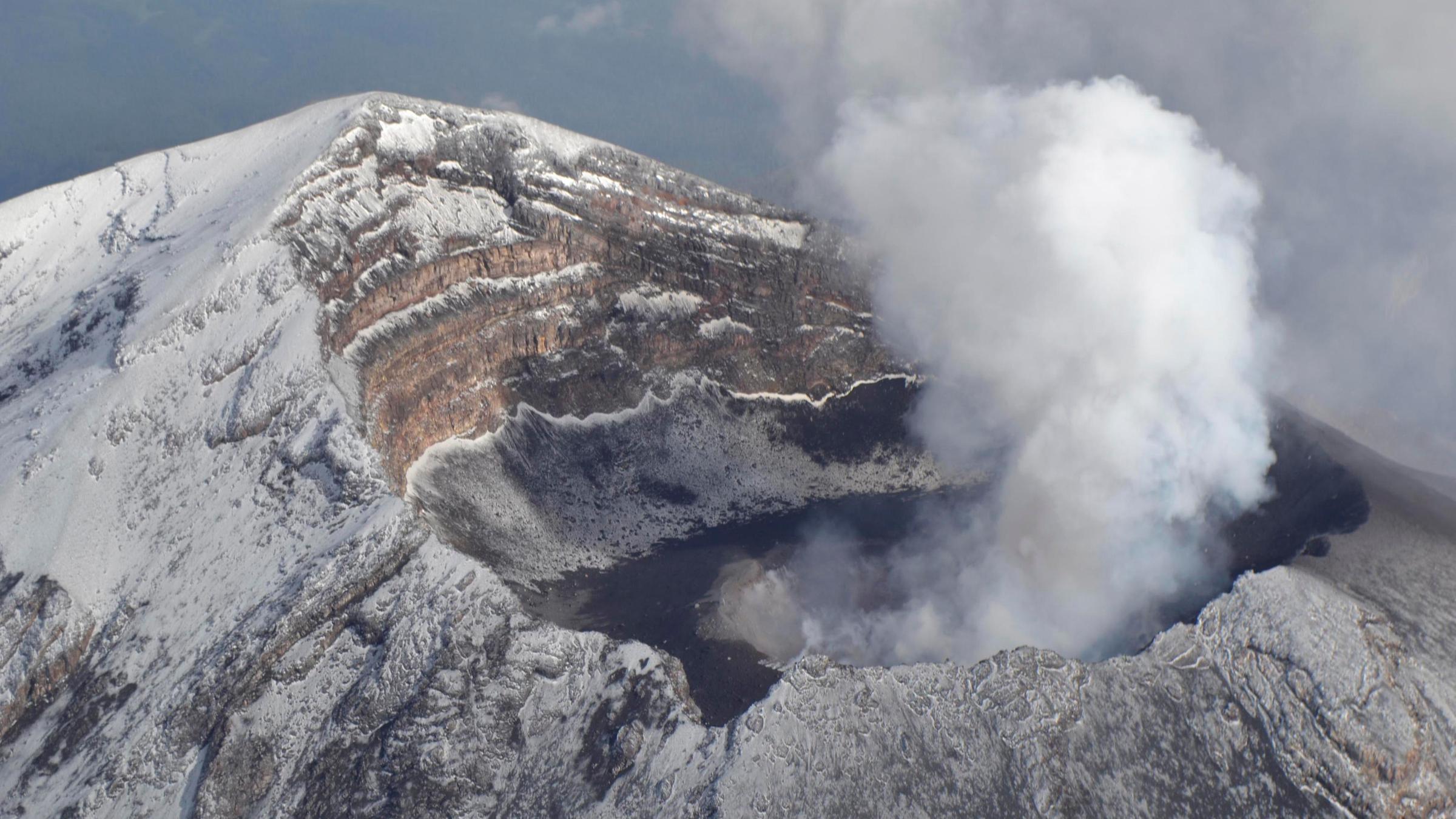 an aerial view of popocatepetl volcano spewing a column of smoke and ash 4,921 ft (1500 metres) high into the sky, in the outskirts of puebla is seen in this june 25, 2013 