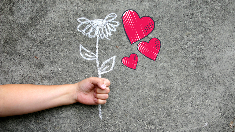 Valentinstag - Hand hält Blumen 