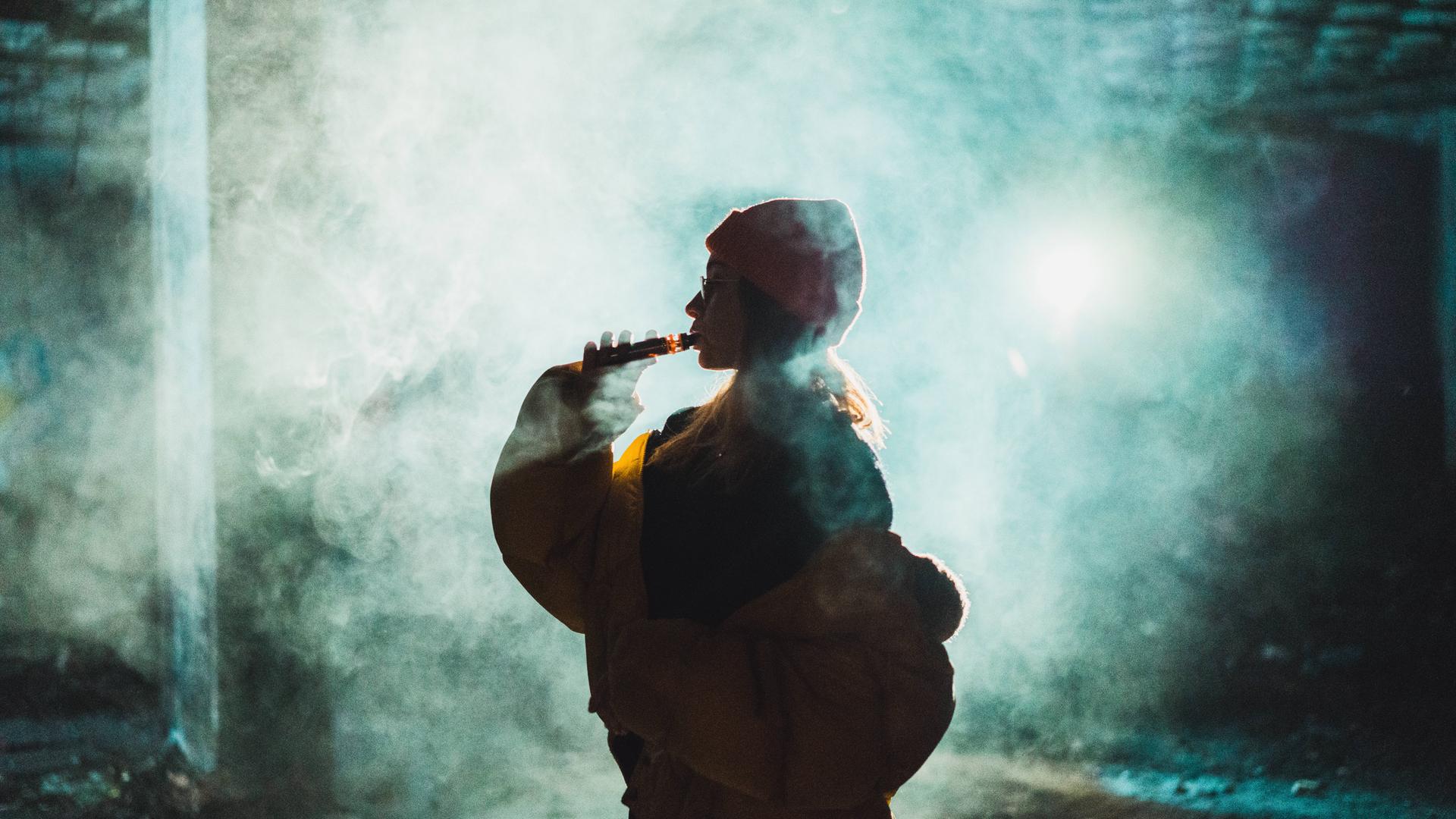 Woman vaping in abandoned building