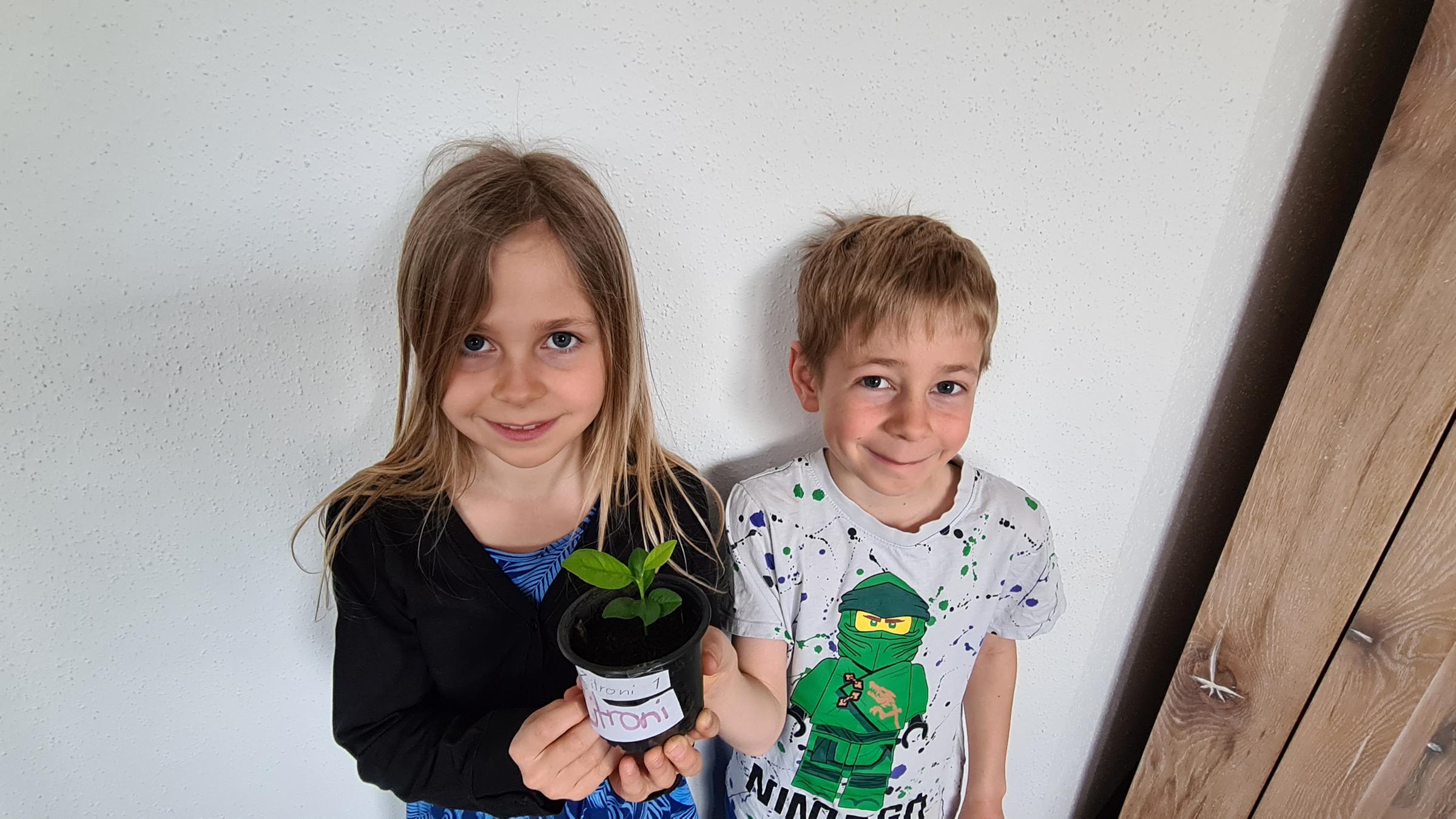 Geschwister Verena und Simon zeigen Zitronenbaum