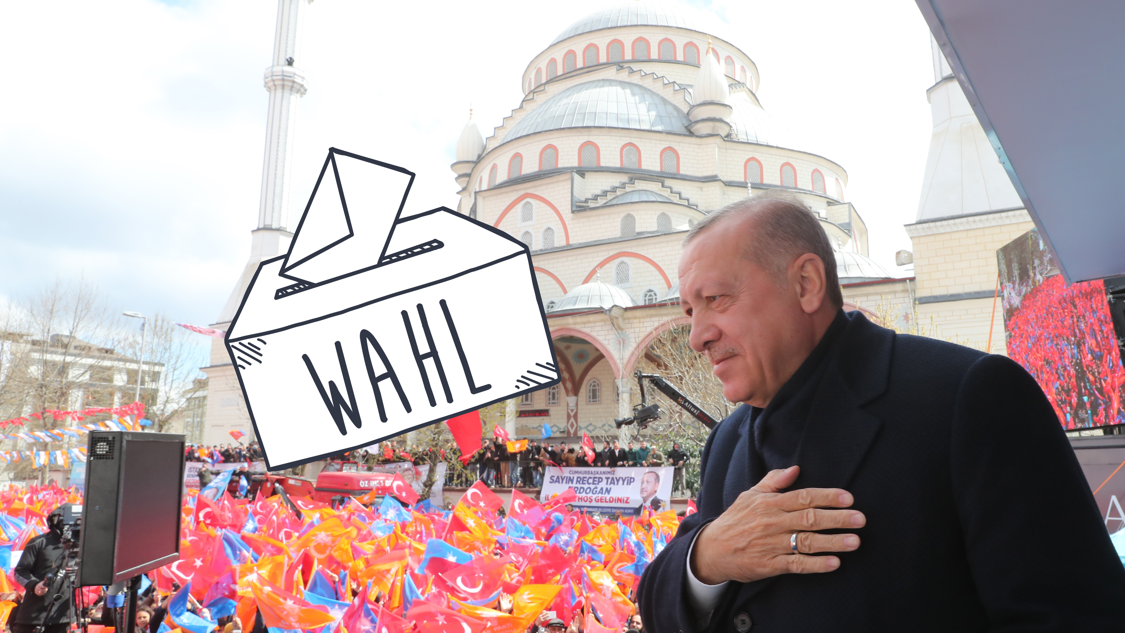 Erdogan steht auf einer Bühne, im Hintergrund sind seine Anhängerinnen und Anhänger und eine Zeichnung einer Wahlurne zu sehen.